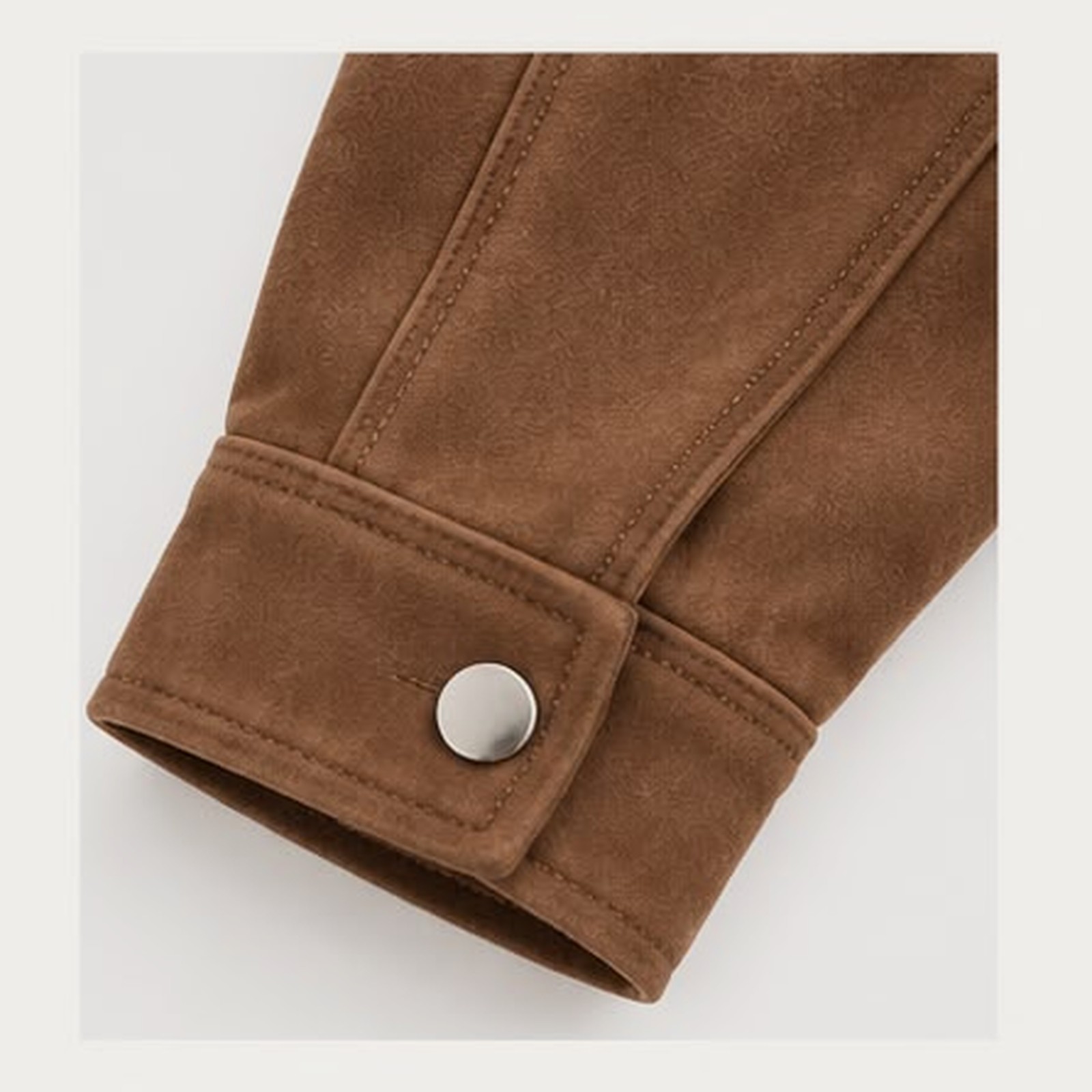 Close view of the cuff: a snapped placket over an elasticated cuff, with a seam running the length of the sleeve.
